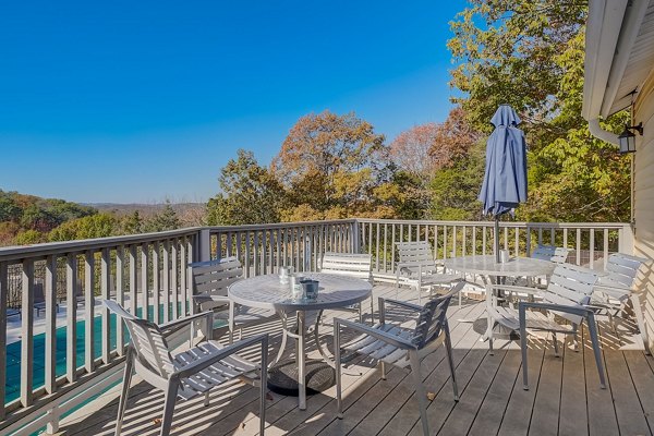 Scenic rooftop deck with modern lounge furniture at Brentwood Oaks Apartments offering panoramic city views
