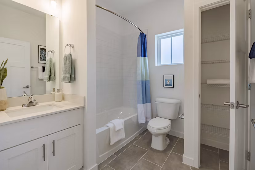 Bathroom featuring elegant fixtures and marble accents in Adaptive Image Eden Magnolia Village Apartments