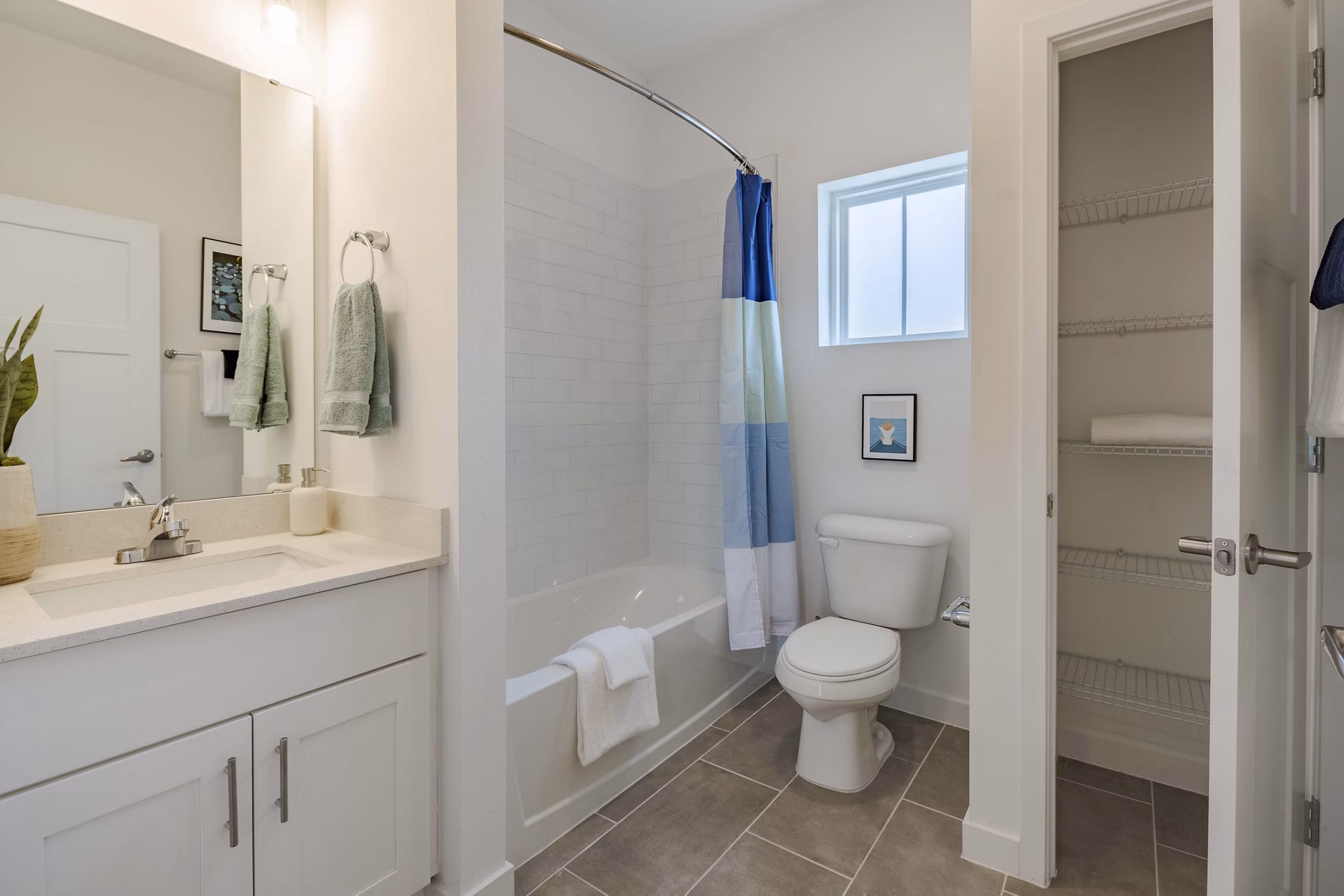 Bathroom featuring elegant fixtures and marble accents in Adaptive Image Eden Magnolia Village Apartments