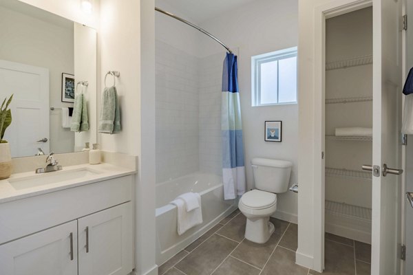Bathroom featuring elegant fixtures and marble accents in Adaptive Image Eden Magnolia Village Apartments