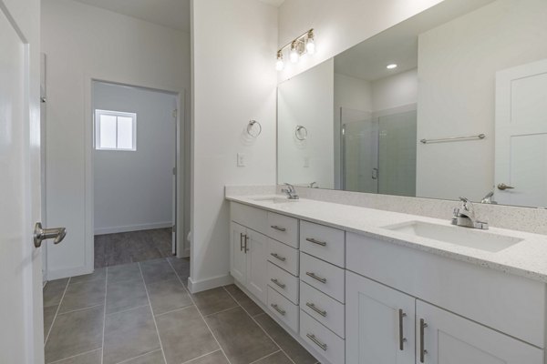 Bathroom featuring modern fixtures at Adaptive Image Eden Magnolia Village Apartments