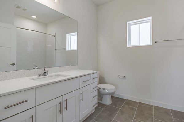 Eden Magnolia Village Apartments: Modern bathroom with sleek fixtures and granite countertops