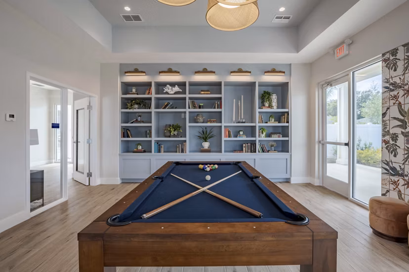 Game room featuring pool table and lounge seating at Eden Magnolia Village Apartments