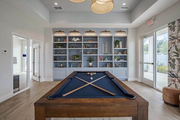 Game room featuring pool table and lounge seating at Eden Magnolia Village Apartments