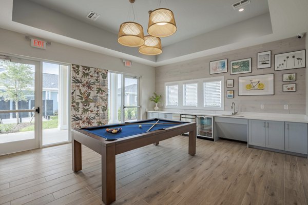 Game room with pool table and arcade machines at Eden Magnolia Village Apartments