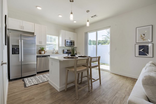 Modern kitchen with sleek appliances at Eden Magnolia Village Apartments