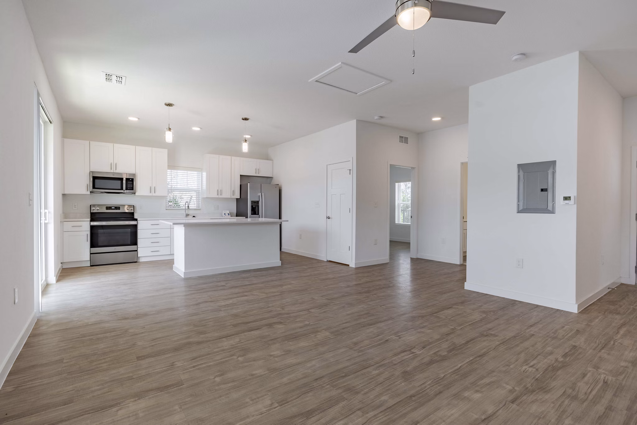 Living room with modern decor and ample natural light in Eden Magnolia Village Apartments, a luxury property by Greystar