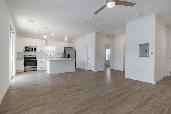 Living room with modern decor and ample natural light in Eden Magnolia Village Apartments, a luxury property by Greystar