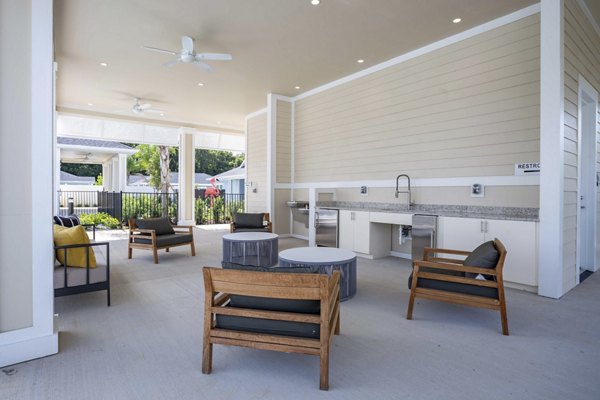 Patio with modern seating and greenery at Eden Magnolia Village Apartments in Seattle