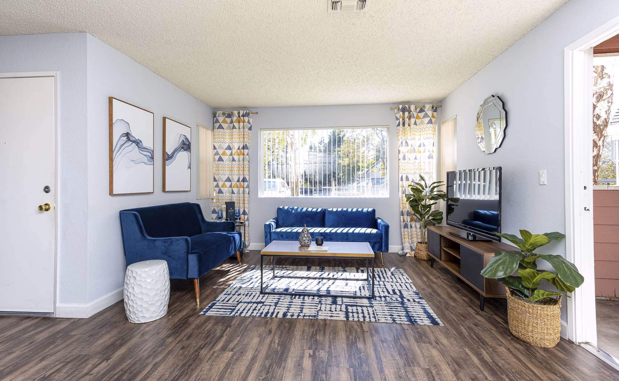 Spacious living room with modern decor and abundant natural light in Sundance Apartments luxury community