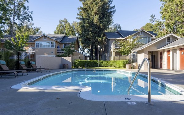 Resort-style pool with lounge chairs at Sundance Apartments