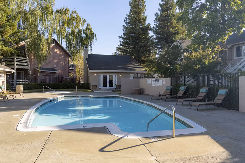 Rooftop pool with lounge chairs at Sundance Apartments offering serene views