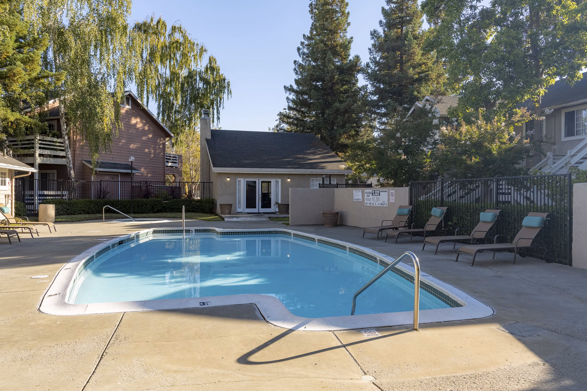 Rooftop pool with lounge chairs at Sundance Apartments offering serene views
