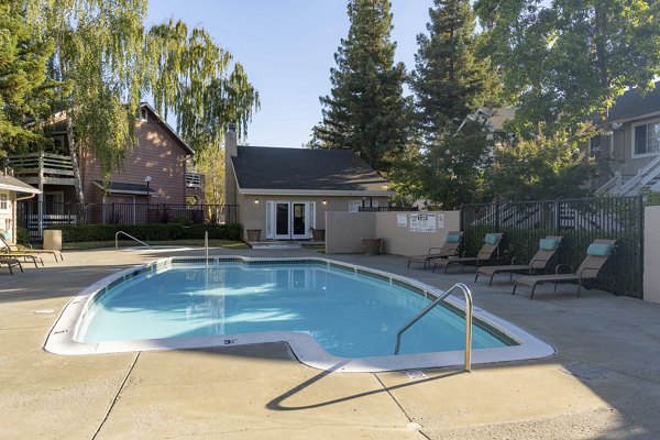 Rooftop pool with lounge chairs at Sundance Apartments offering serene views