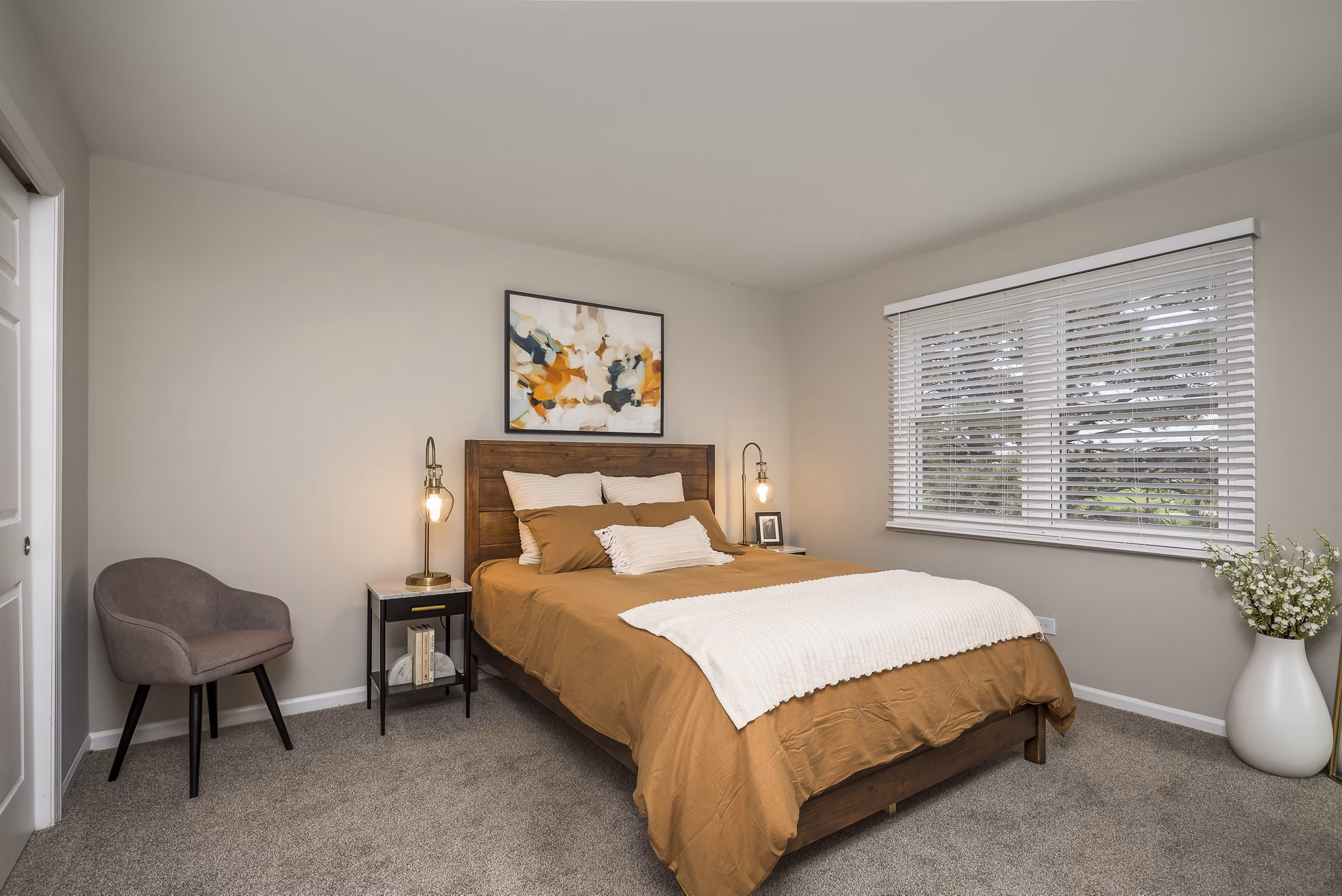 Master bedroom with elegant decor and large windows at Haven on Long Grove Apartments