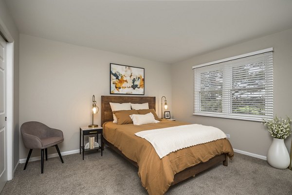 Master bedroom with elegant decor and large windows at Haven on Long Grove Apartments