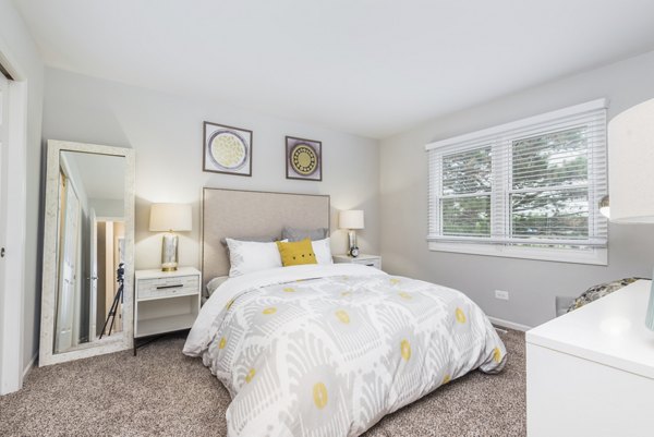 Haven on Long Grove Apartments: Modern bedroom with stylish decor and ample natural light
