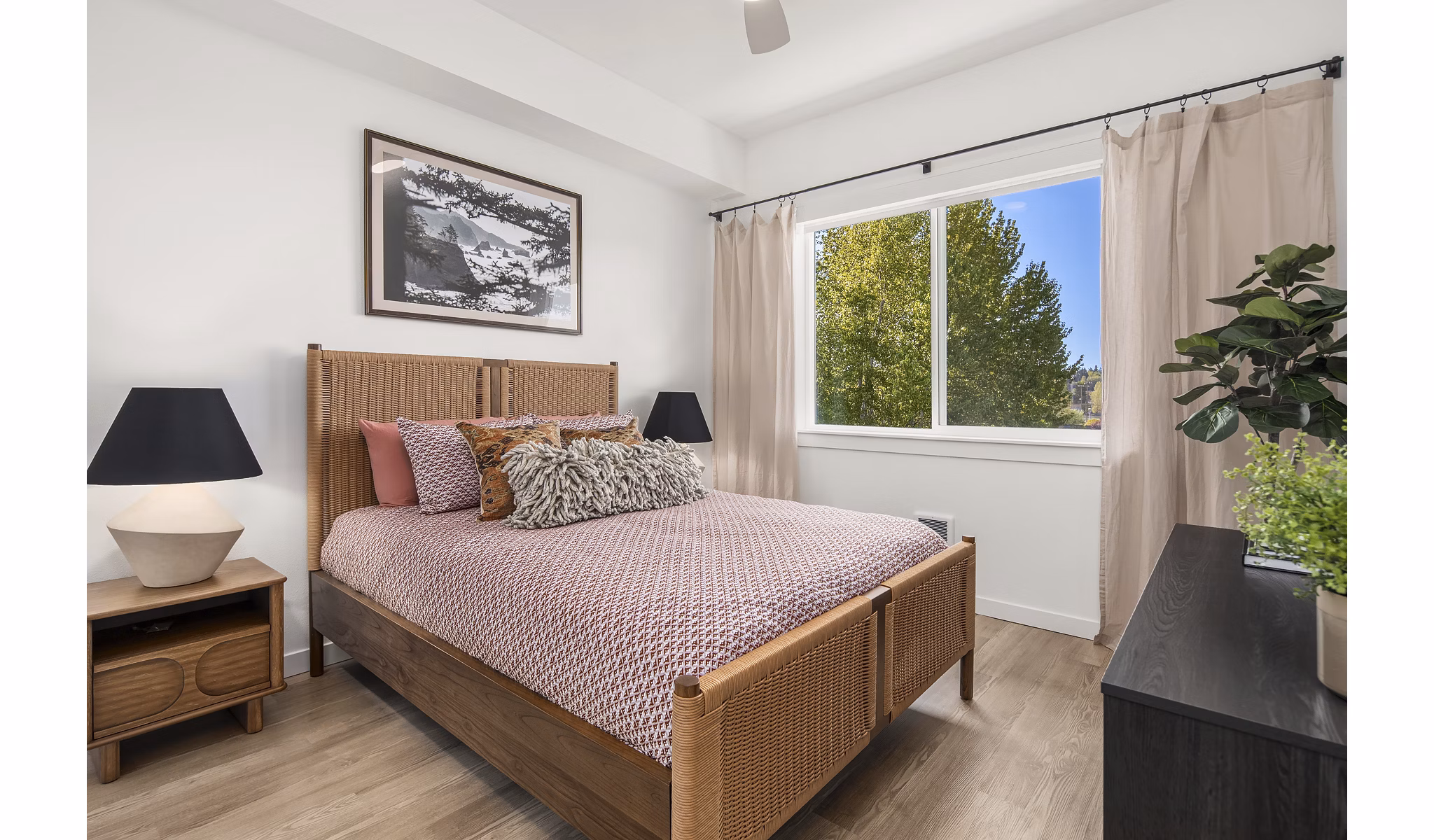 Cozy bedroom with modern decor at Prose Kent Station Apartments featuring plush bedding and ambient lighting