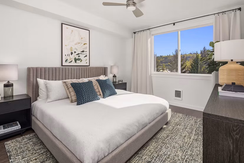 Cozy bedroom with modern decor at Prose Kent Station Apartments, featuring natural light and ample space for relaxation