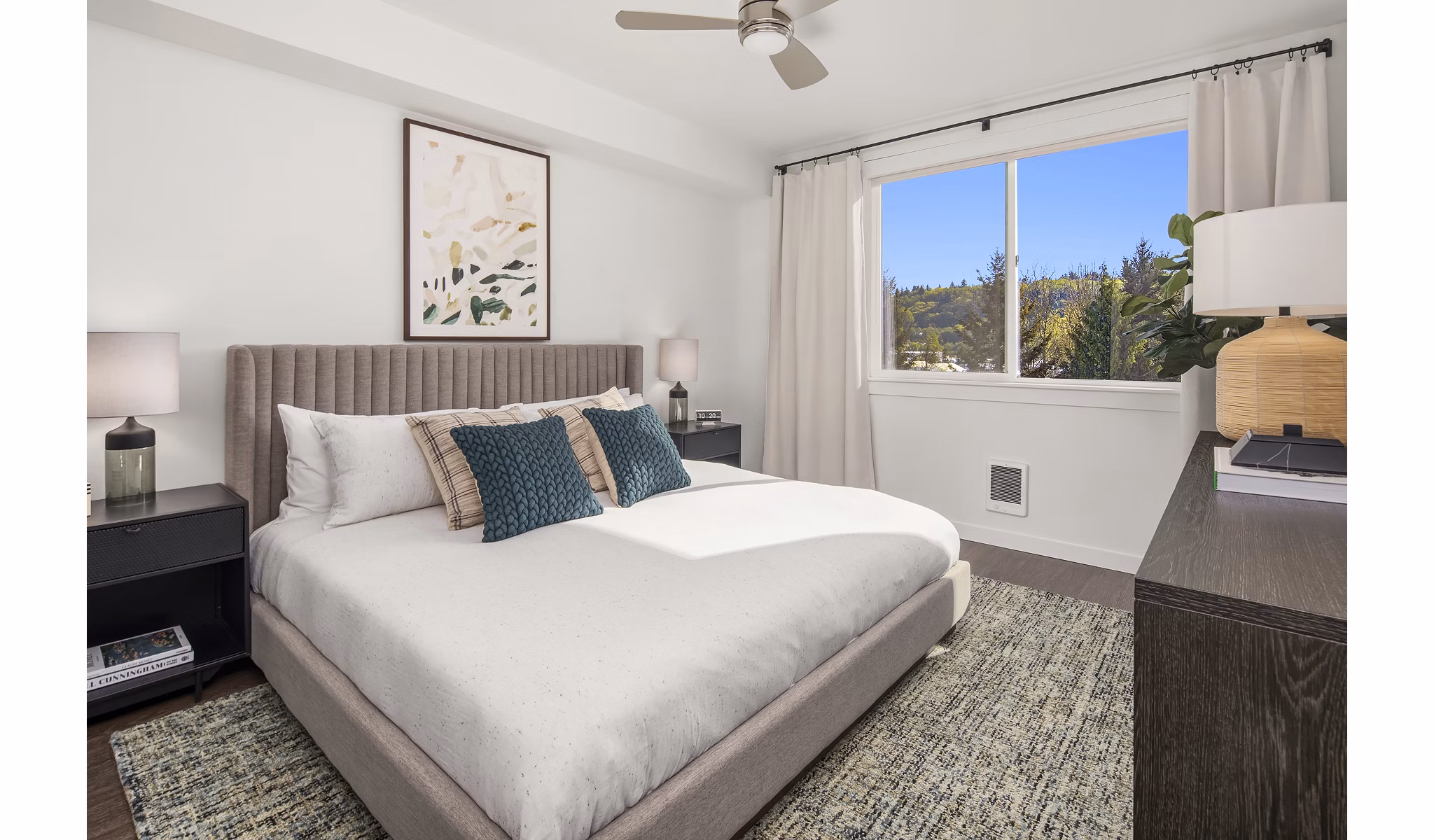 Cozy bedroom with modern decor at Prose Kent Station Apartments, featuring natural light and ample space for relaxation