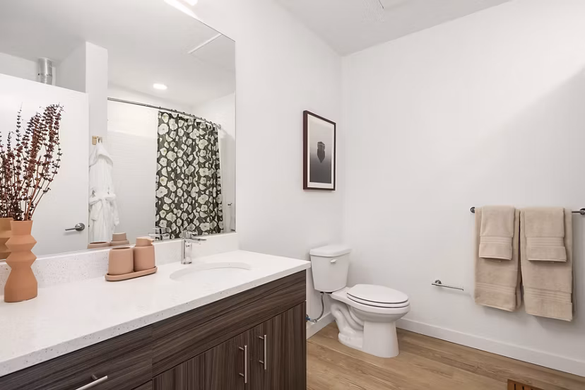 Bright bathroom with modern fixtures at Prose Kent Station Apartments, featuring a luxurious vanity and spacious shower area