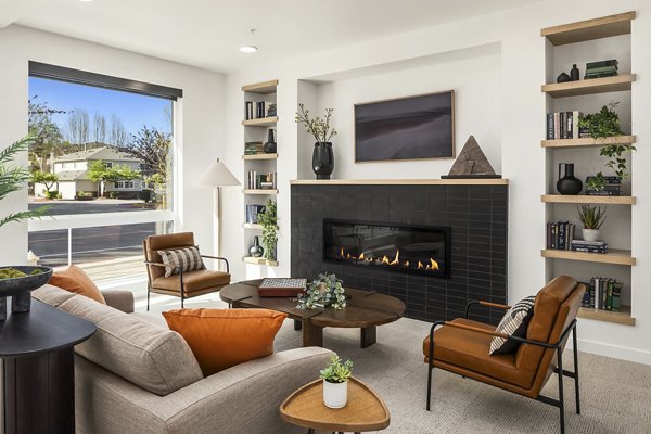 Clubhouse with modern design and seating areas at Prose Kent Station Apartments in Kent, offering luxurious community spaces