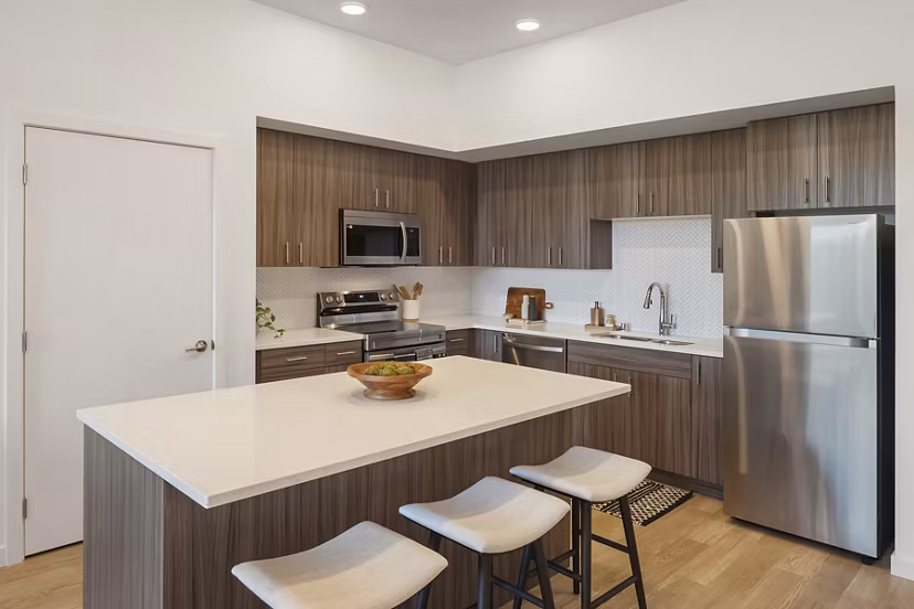 Modern kitchen with stainless steel appliances at Prose Kent Station Apartments