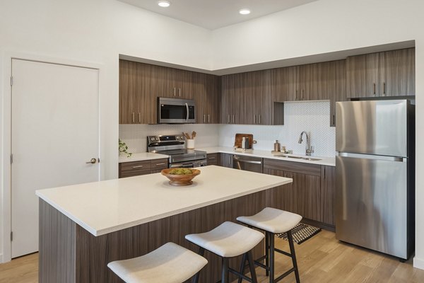 Modern kitchen with stainless steel appliances at Prose Kent Station Apartments