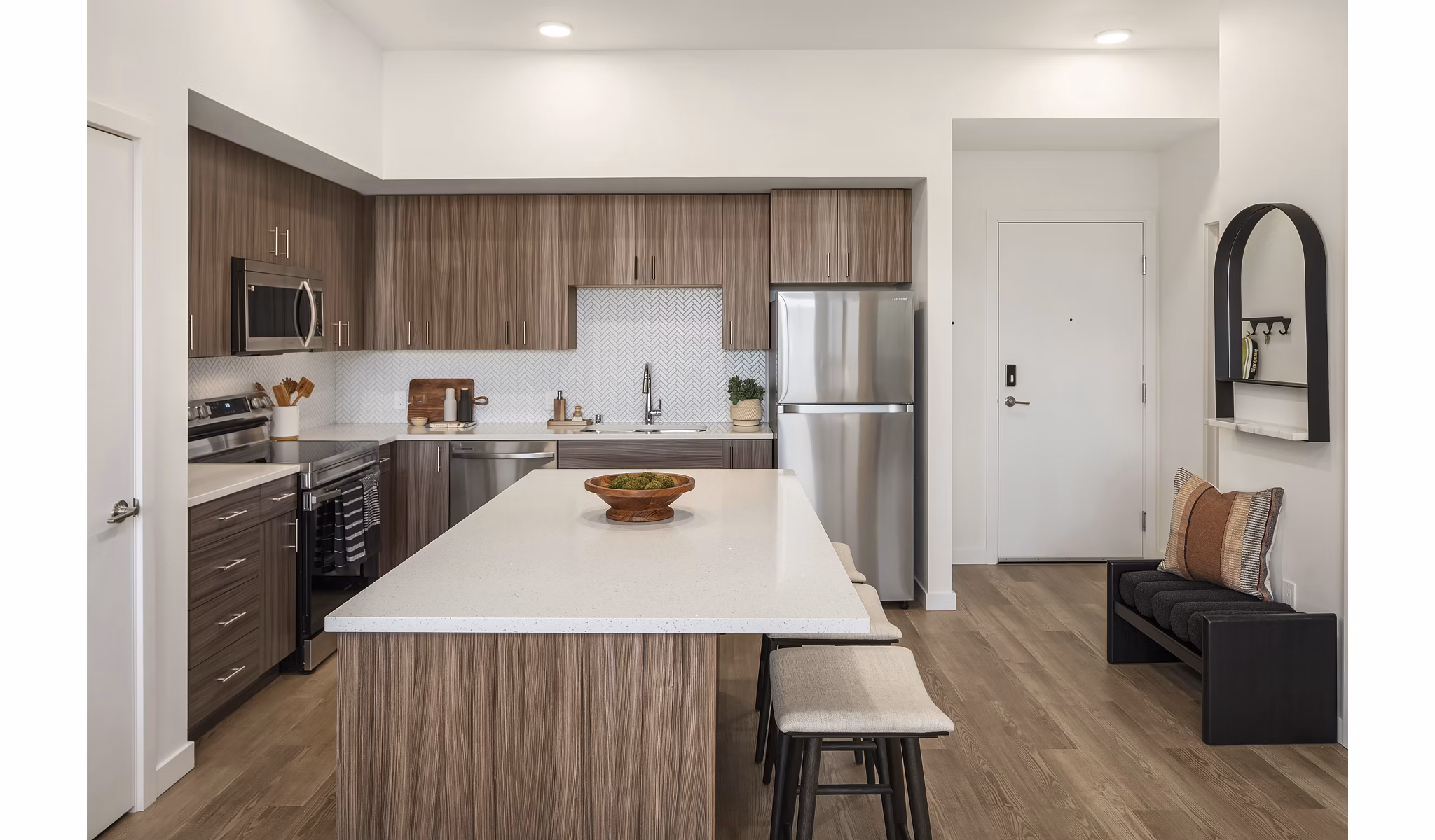 Modern kitchen with stainless steel appliances and granite countertops at Prose Kent Station Apartments