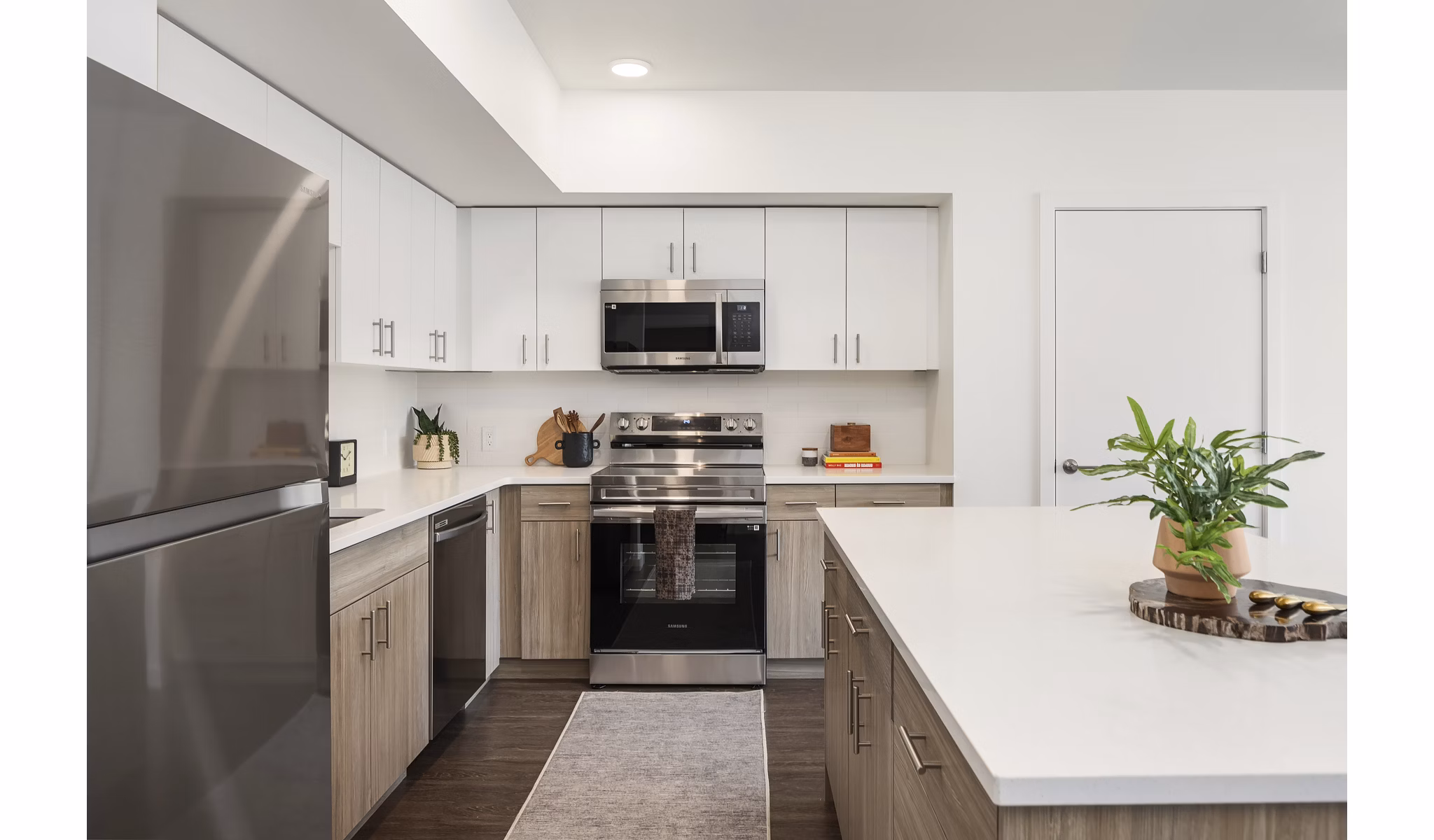 Modern kitchen with stainless steel appliances and sleek countertops at Prose Kent Station Apartments, offering luxury living spaces