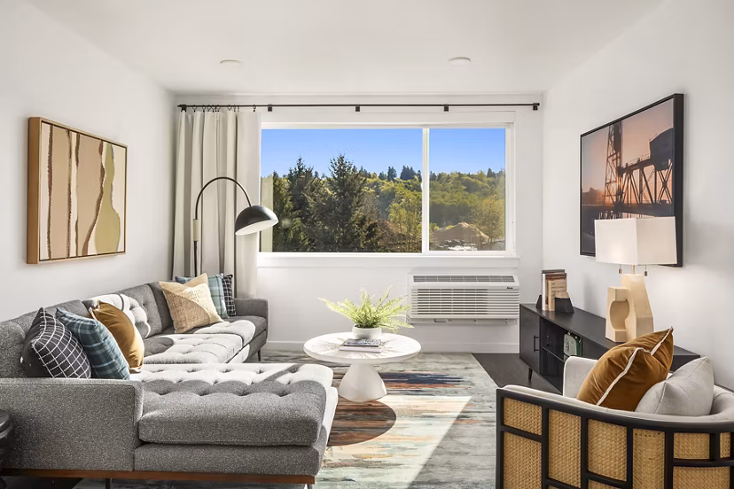Cozy living room with plush furniture and natural light at Prose Kent Station Apartments, ideal for relaxation and comfort