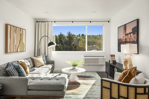 Cozy living room with plush furniture and natural light at Prose Kent Station Apartments, ideal for relaxation and comfort