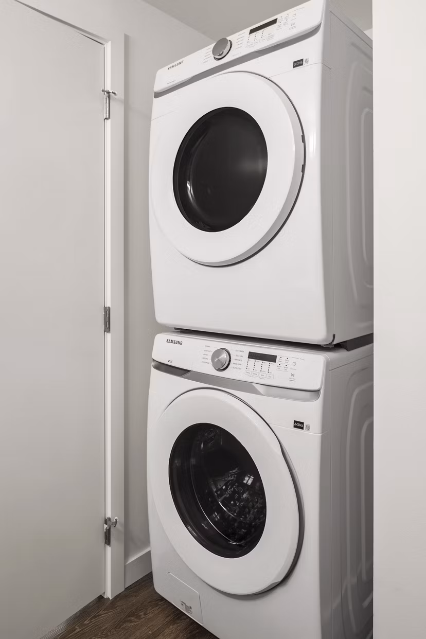 Laundry room featuring modern appliances at Prose Kent Station Apartments