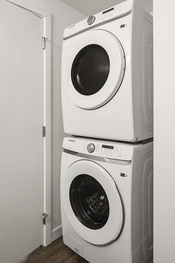 Laundry room featuring modern appliances at Prose Kent Station Apartments