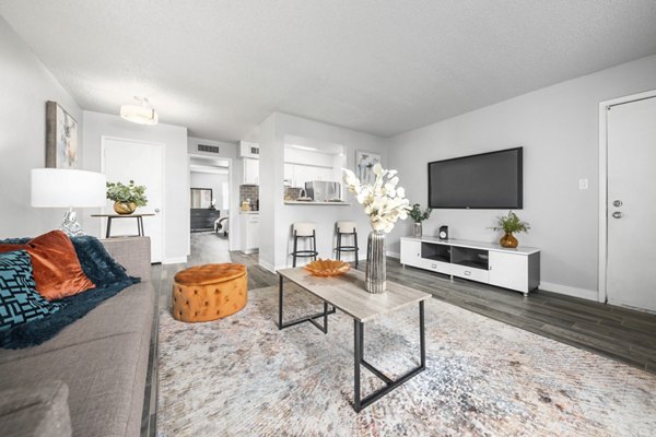 Spacious living room with modern furniture at Sierra Pines Apartments