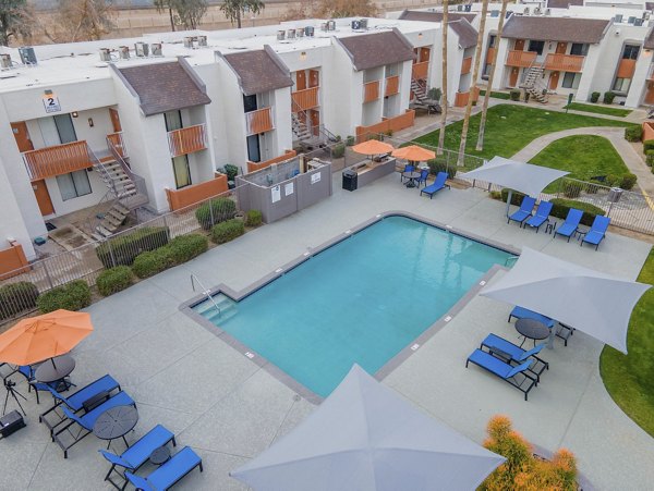 Relaxing pool surrounded by lush greenery at Sierra Pines Apartments