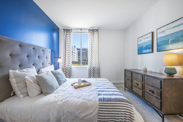 Contemporary bedroom with sleek furnishings in Flats on D Apartments