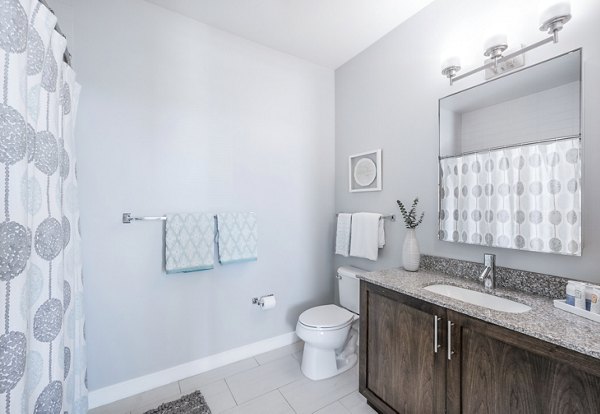 Bathroom featuring modern fixtures and elegant design at Flats on D Apartments