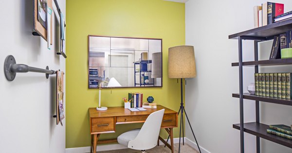 Home office with ergonomic desk and chair at Flats on D Apartments, perfect for remote work in a stylish urban setting