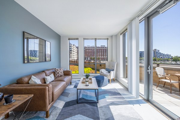 Modern living room with sleek furniture and large windows at Flats on D Apartments