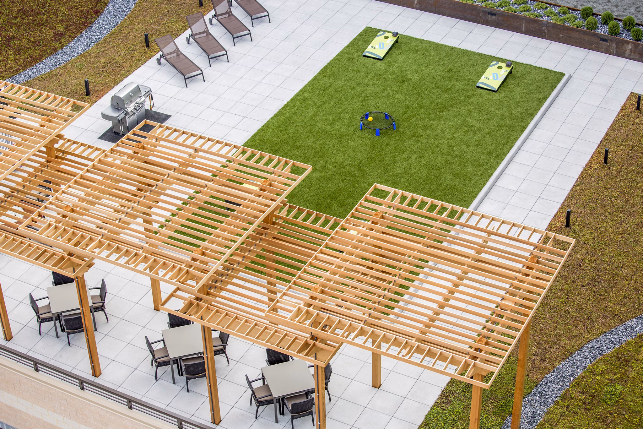Outdoor grilling area with modern patio furniture at Flats on D Apartments, perfect for social gatherings and relaxation