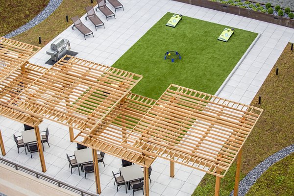 Outdoor grilling area with modern patio furniture at Flats on D Apartments, perfect for social gatherings and relaxation