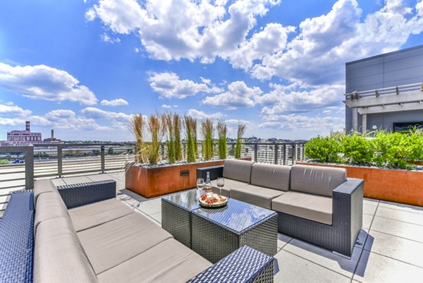 Cozy patio area with modern seating at Flats on D Apartments, perfect for relaxing outdoors