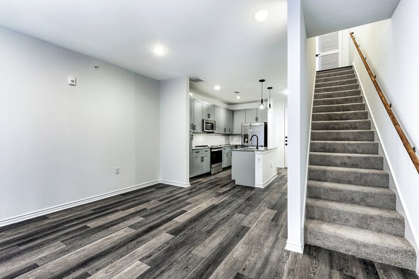 living room and stairway at Oak House Apartments