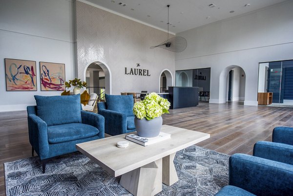 Clubhouse with modern furnishings and spacious seating at The Laurel Apartments