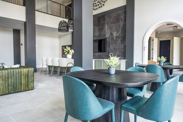 Clubhouse with modern furnishings and open seating areas at The Laurel Apartments, a luxury property