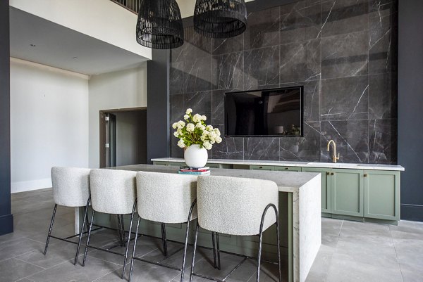 Spacious clubhouse with modern seating and large windows at The Laurel Apartments