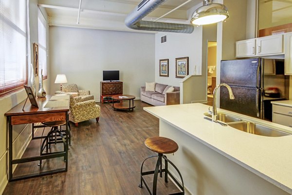 Open-concept kitchen with stainless steel appliances at Heinz Lofts Apartments