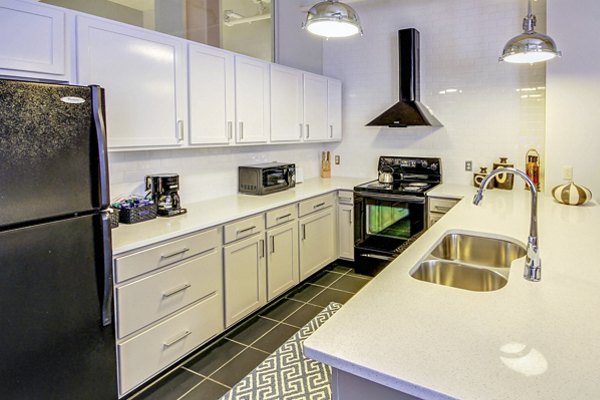 Modern kitchen with sleek countertops and stainless steel appliances in Heinz Lofts Apartments