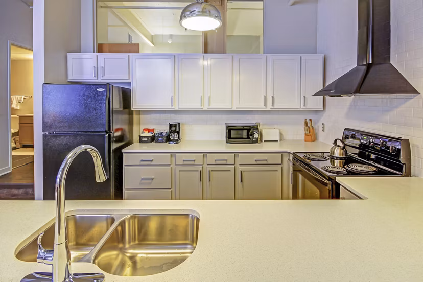 Modern kitchen with stainless steel appliances at Heinz Lofts Apartments, Greystar luxury apartments in urban setting